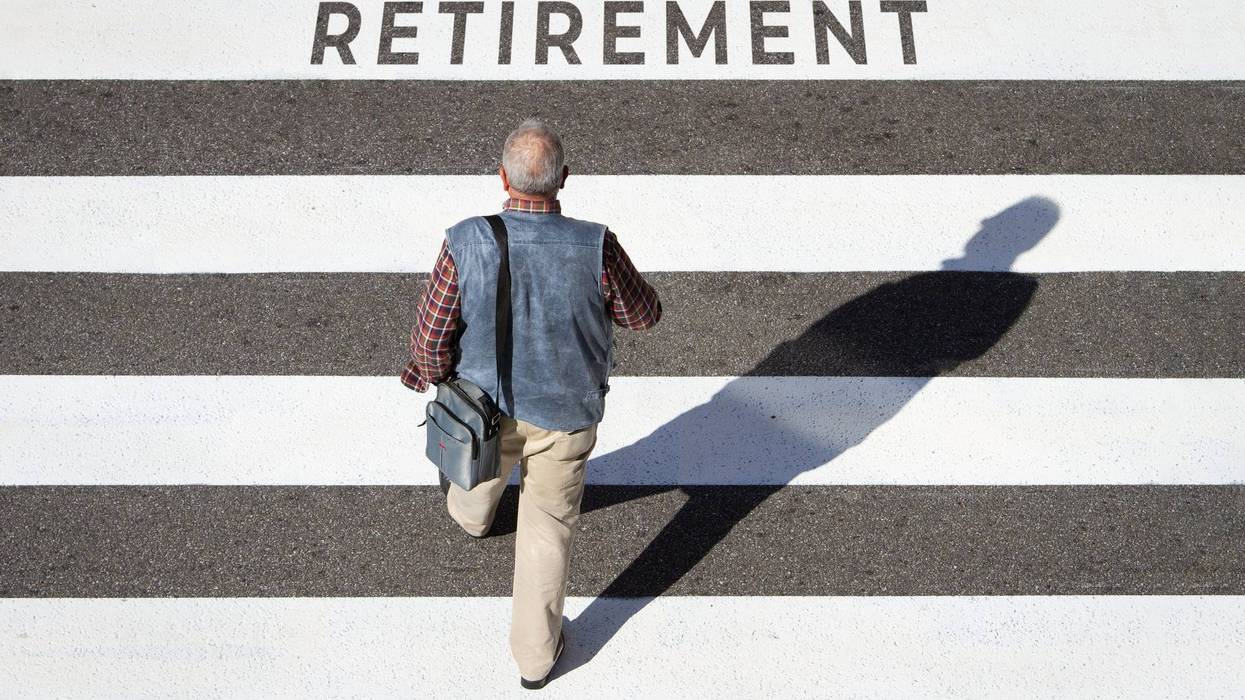 Scene of a senior man walking towards retirement text