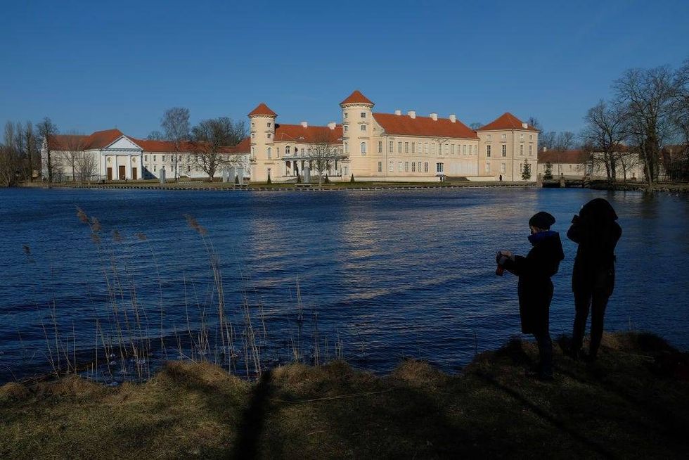 Schloss Rheinsberg palace stands at the edge of Grienericksee lake in Brandenburg state on March 18, 2018 in Rheinsberg, Germany. Schloss Rheinsberg served mainly as home to various Prussian royalty, including Frederick William I and his son, Frederick the Great.