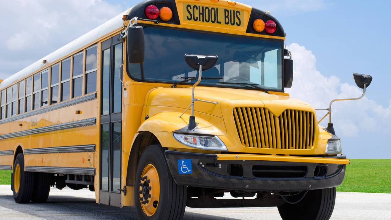 School bus on blacktop with clean sunny background