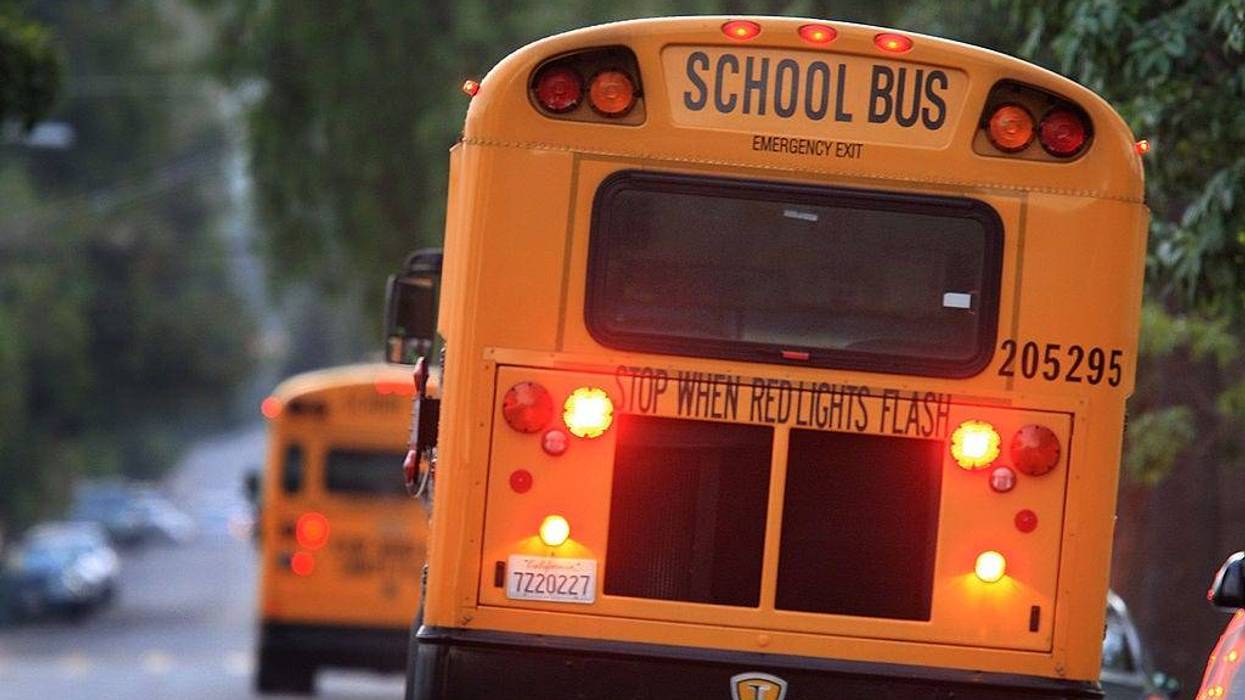 School buses drive down teh road to pick up children before classes begin on October 10, 2008 in Pasadena, California.