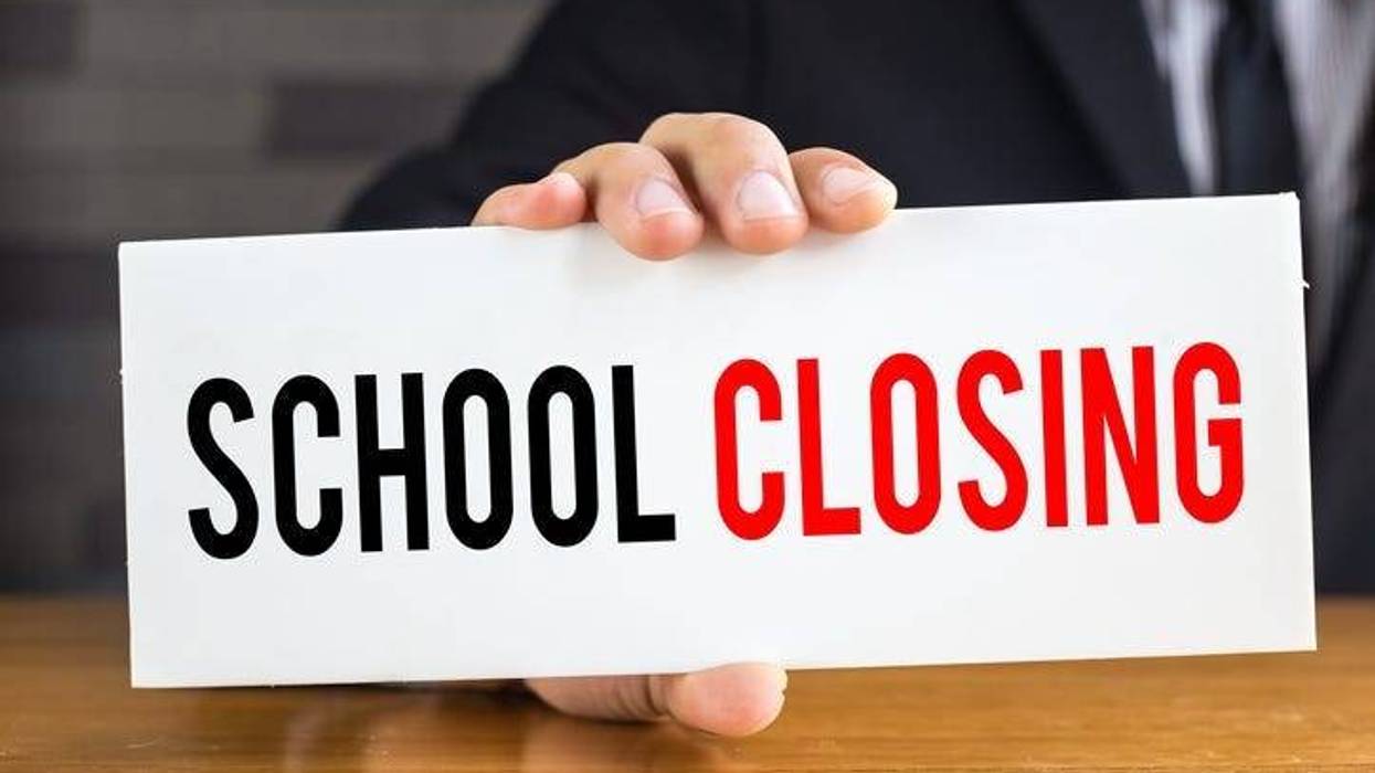 School closing, message on white card and hold by businessman