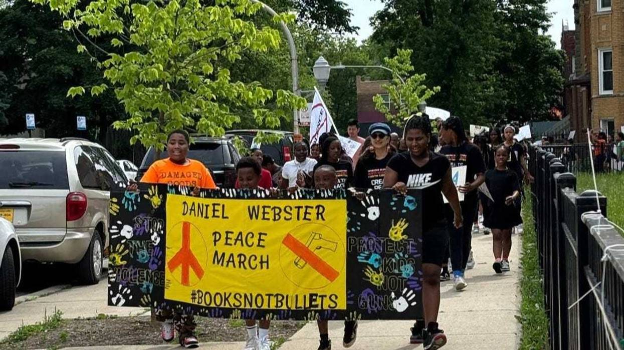 School officials from Daniel Webster Elementary and a police escort led students on their march through the streets of North Lawndale on Tuesday.