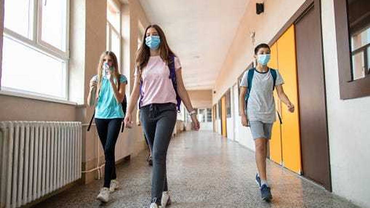 School students walking down a hallway between classes