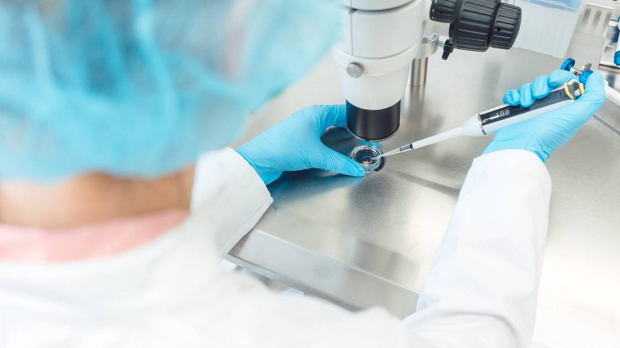 Scientist working with pipette in laboratory.