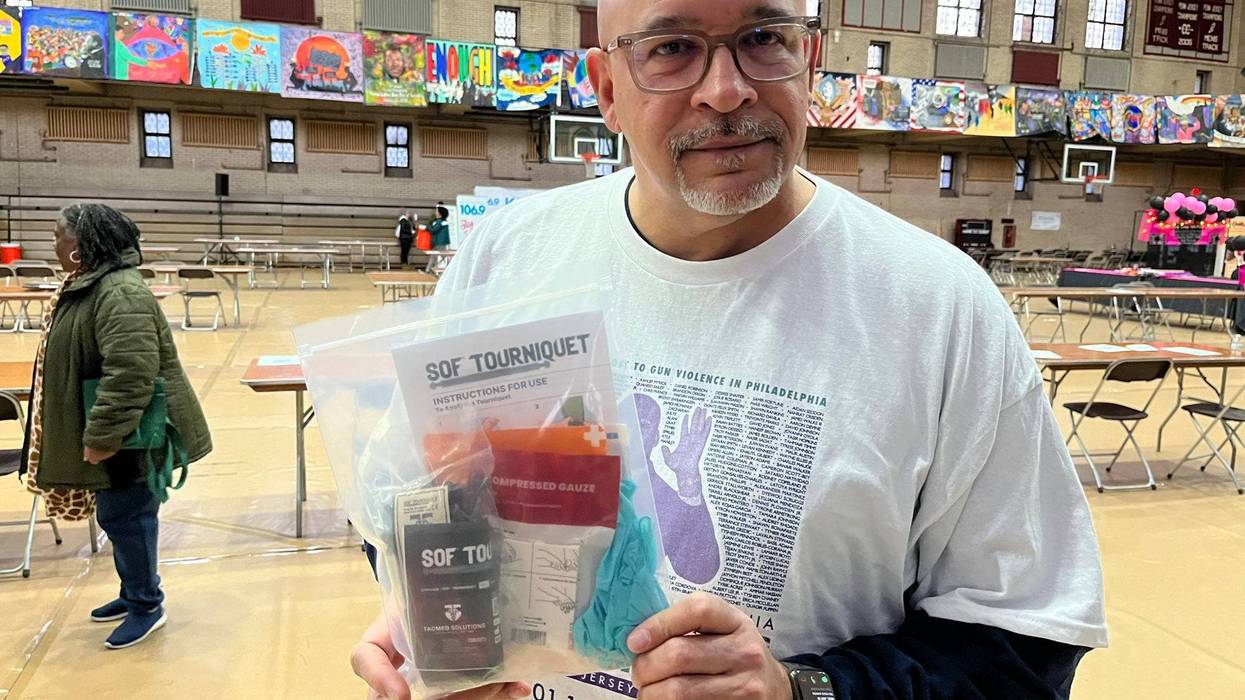 Scott Charles, Temple Hospital’s trauma outreach manager, holds a gun violence prevention kit that volunteers are making during the 28th annual Greater Philadelphia MLK Day of Service at Girard College, Jan. 16, 2023.