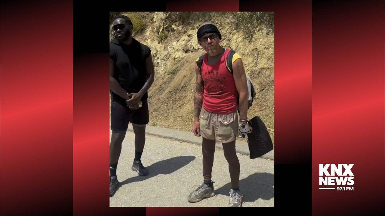 Scott Mitchell (standing left) is standing with Andrew O’Calliham (right) after O’Calliham was reportedly seen setting a palm tree on fire in Runyon Canyon.