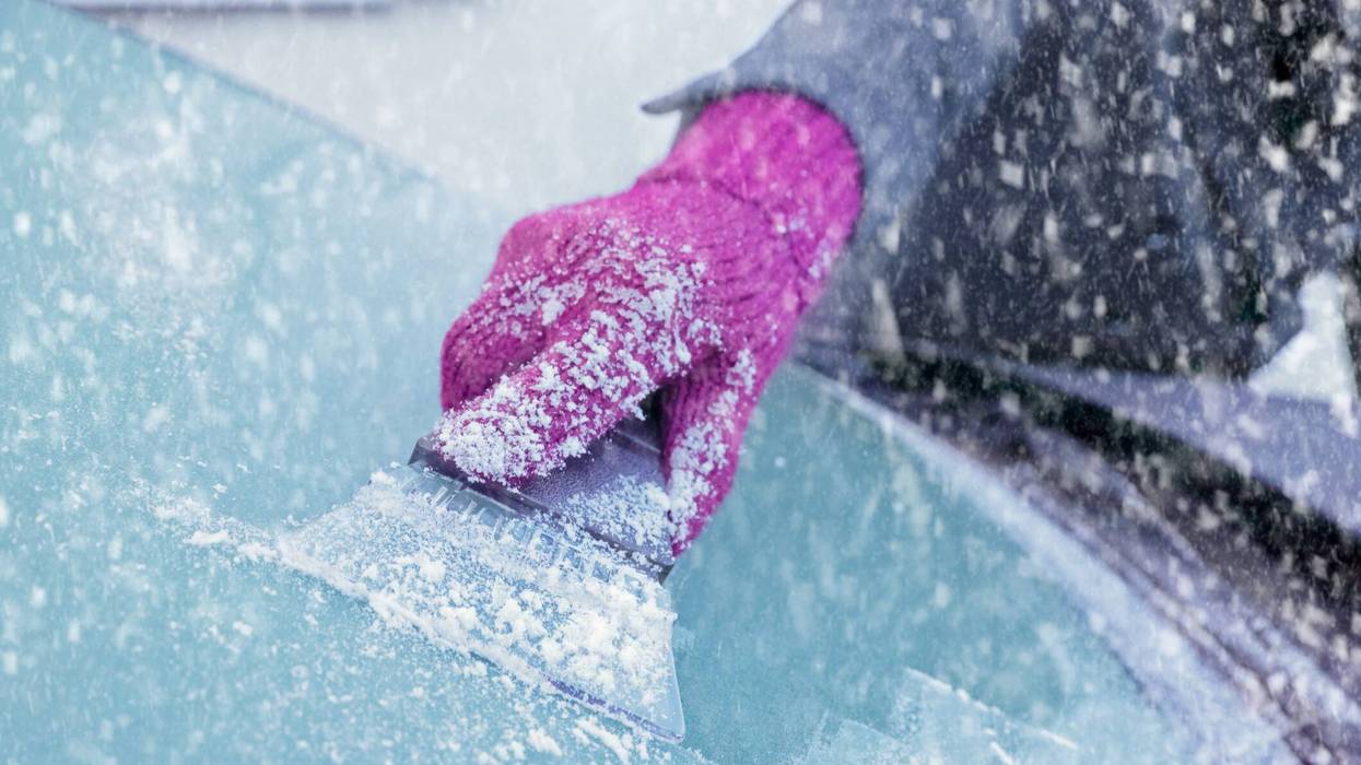 Scraping ice from a windshield