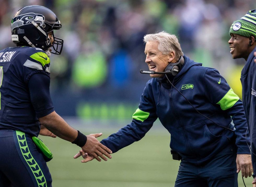 Seahawks coach Pete Carroll congratulates quarterback Russell Wilson after a big play