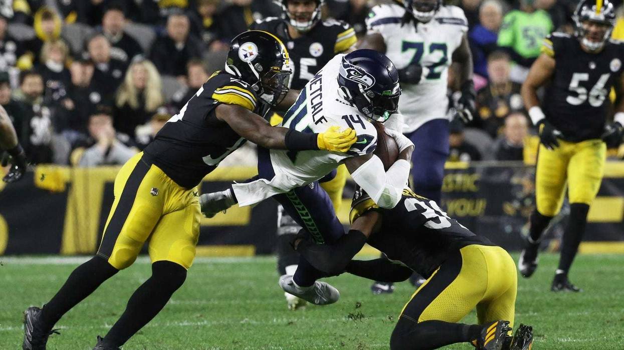 Seahawks wide receiver DK Metcalf (14) is tackled after a catch