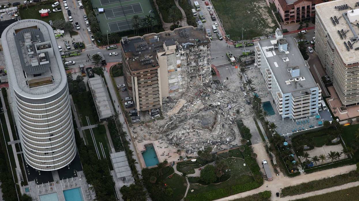 Search and rescue personnel work in the rubble of the 12-story condo tower that crumbled to the ground after a partial collapse of the building on June 24, 2021 in Surfside, Florida.