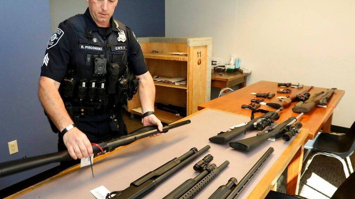 Seattle Police Crisis Response Team Sgt. Eric Pisconski displays guns seized from people deemed to be a danger to themselves or others