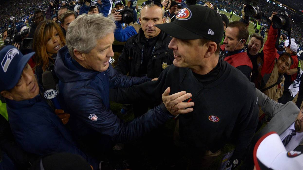 Seattle Seahawks coach Pete Carroll (right) and San Francisco 49ers coach Jim Harbaugh shake hands after the 2013 NFC Championship football game at CenturyLink Field.