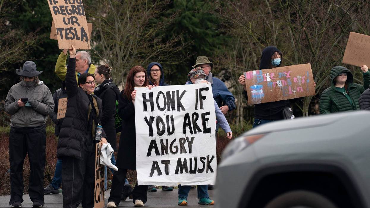 SEATTLE, WASHINGTON - FEBRUARY 22: Demonstrators gather for a protest against Elon Musk and electric car maker Tesla on February 22, 2025 in Seattle, Washington. Hundreds rallied at various entrances to the University Village shopping mall, in addition to the Tesla showroom's storefront at the mall. (Photo by David Ryder/Getty Images)
