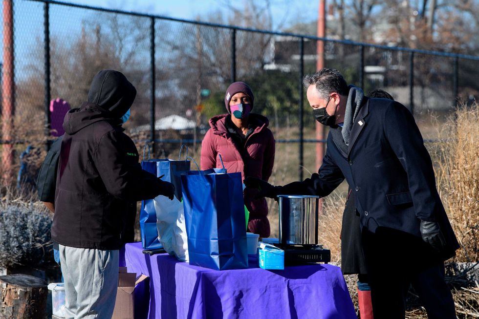 Second gentleman Doug Emhoff, the spouse of Vice President Kamala Harris, speaks with volunteers of Dreaming out Loud, a nonprofit organization focused on food security and economic opportunity, during a visit to Kelly Miller Middle School in Washington, Thursday, Jan. 28, 2021.
