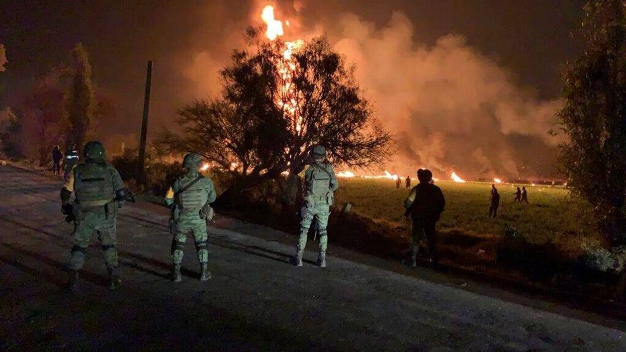 Secretary of National Defense, soldiers guard the area by an oil pipeline explosion in Tlahuelilpan, Hidalgo state, Mexico, Friday, Jan. 18, 2019.