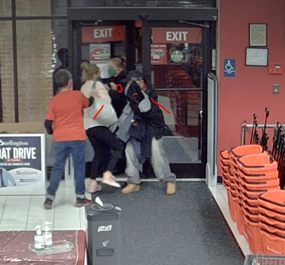 Security footage of suspects forcing their way out the business