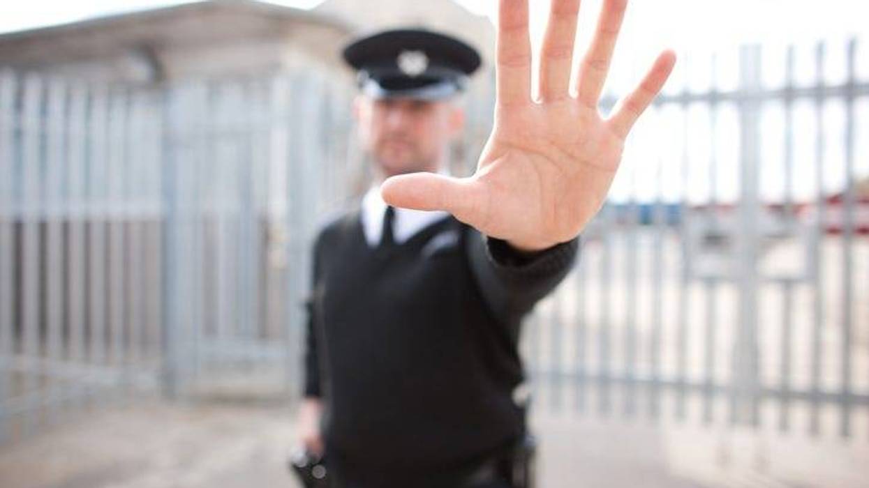 Security guard holding hand out