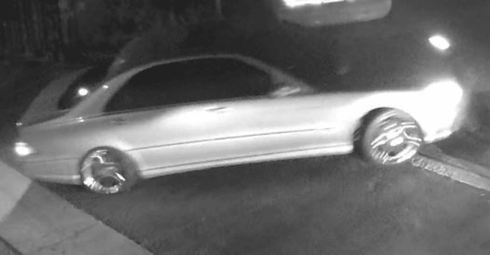 security snapshot of light colored sedan