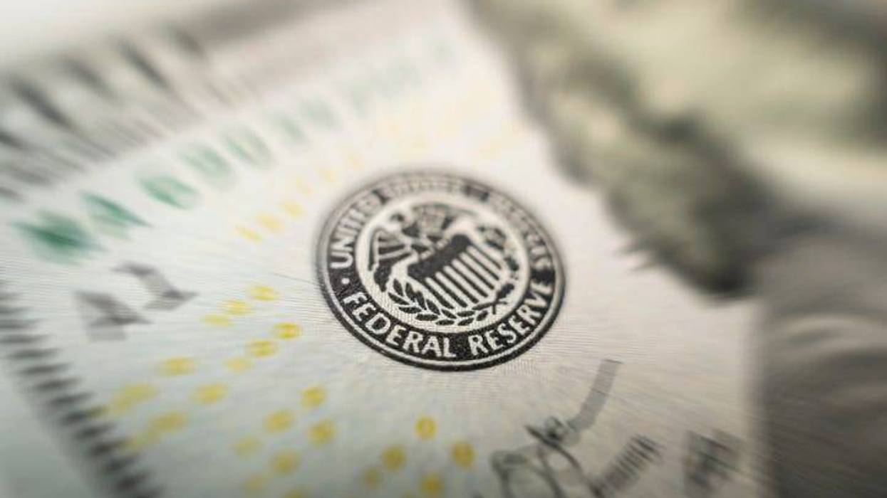 Selective focus on US Federal Reserve emblem on hundred dollars banknote as FED consider interest rate hike, economics and inflation control national organization