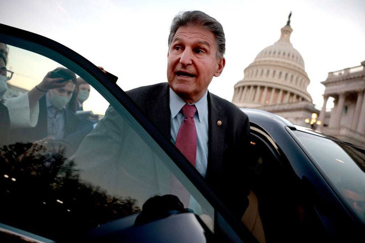 Sen. Joe Manchin (D-WV) is followed to his car by reporters after participating in a vote at the U.S. Capitol Building on December 14, 2021 in Washington, DC. The Senate voted to pass legislation raising the national debt limit, which will now move to the House of Representatives for final passage. (Photo by Anna Moneymaker/Getty Images)