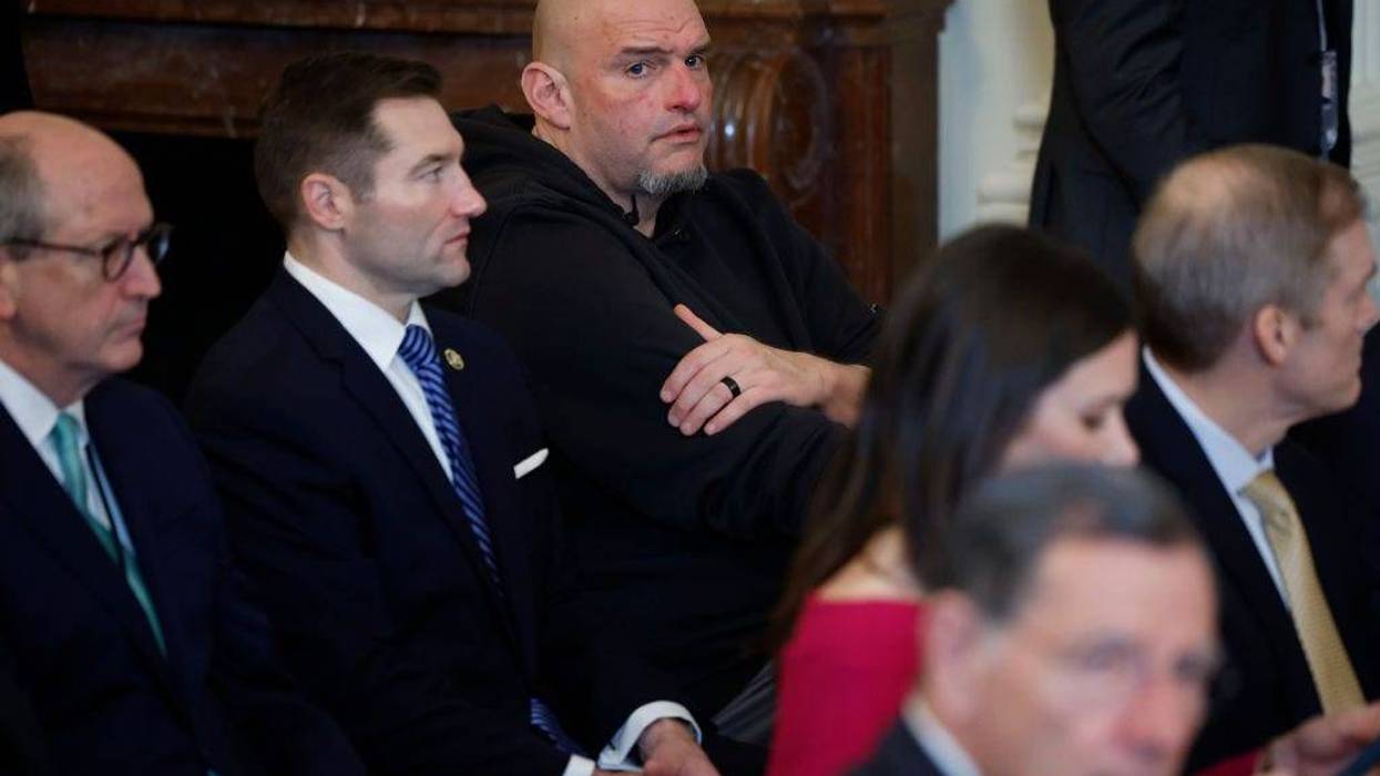 Sen. John Fetterman (D-PA) (C) joins other lawmakers for the signing ceremony for the Laken Riley Act