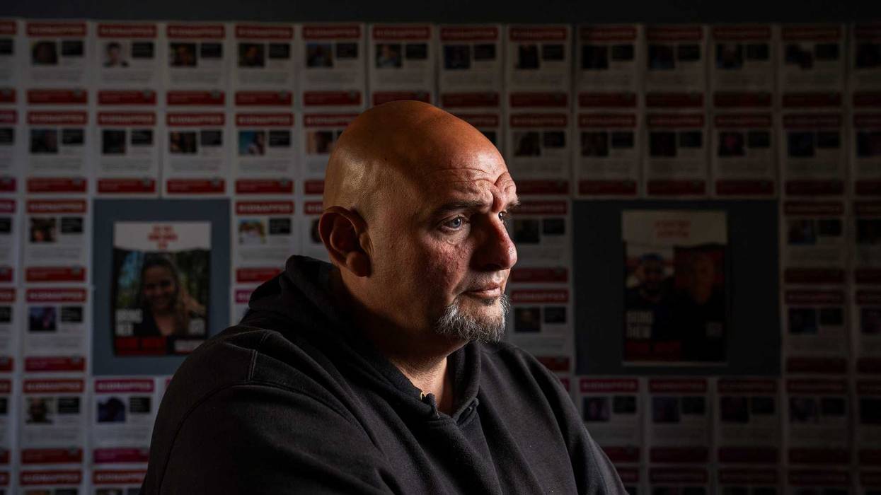 Sen. John Fetterman, D-Pa., poses for a portrait in front of posters of Israeli hostages in his front office at the U.S. Capitol