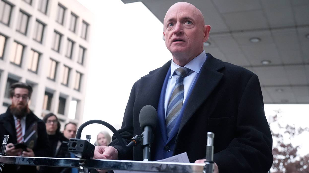 Sen. Mark Kelly, D-Ariz.,speaks to reporters outside of federal court in Washington, Tuesday, Feb. 3, 2026.