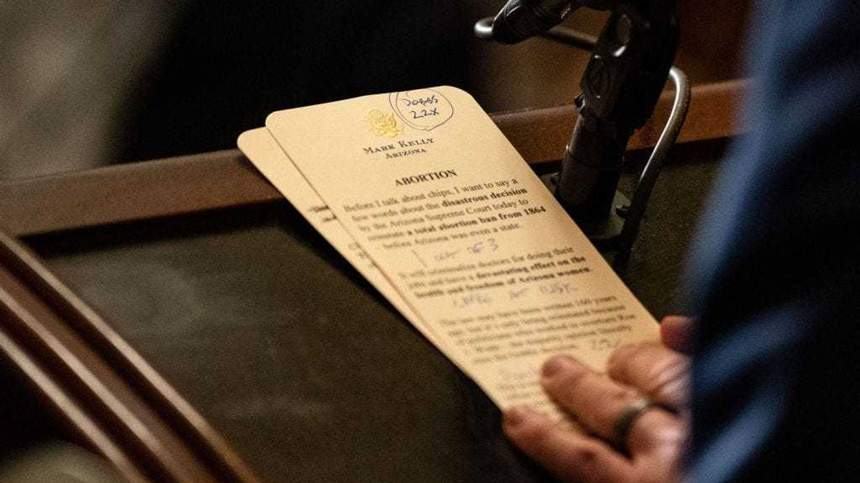 Sen. Mark Kelly (D-AZ) holds his notes as he speaks during a news conference following a Senate Democratic party policy luncheon at the U.S. Capitol Building on April 9, 2024 in Washington, DC. Senate leadership spoke to reporters on a range of topics including electric vehicles, the Arizona Supreme Court ruling issuing a near-total ban on abortion and the looming impeachment trial of Secretary of Homeland Security Alejandro Mayorkas. (Photo by Kent Nishimura/Getty Images)