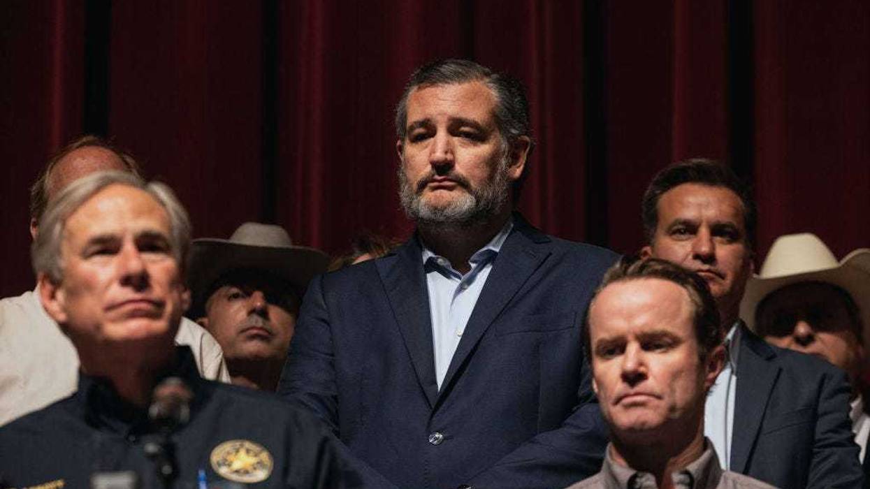 Sen. Ted Cruz (R-TX) looks on as Texas Gov. Greg Abbott speaks during a press conference at Uvalde High School on May 25, 2022 in Uvalde, Texas. On May 24, 21 people were killed, including 19 children, during a mass shooting at Robb Elementary School. The shooter, identified as 18-year-old Salvador Ramos, was reportedly killed by law enforcement. (Photo by Jordan Vonderhaar/Getty Images)