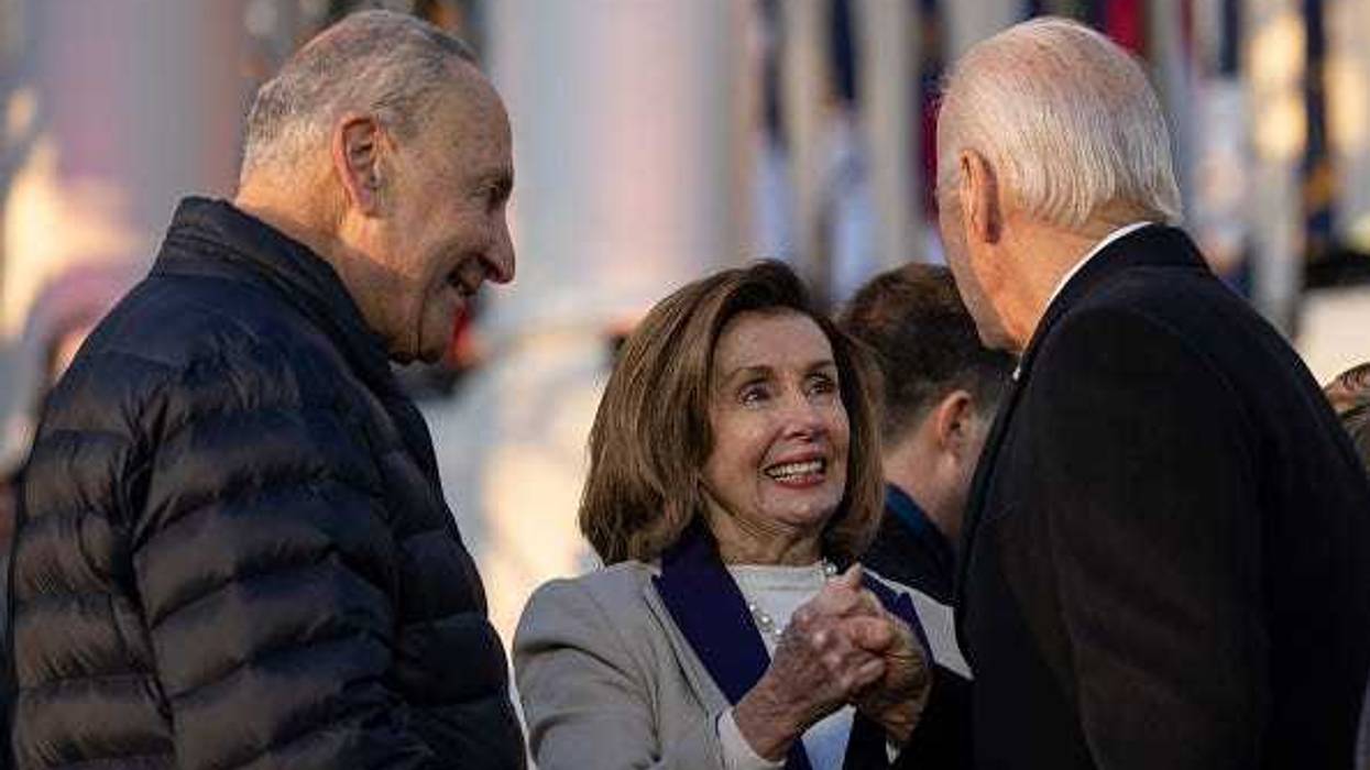 Senate Majority Leader Chuck Schumer (D-NY) looks on as Speaker of the House Nancy Pelosi (D-CA) shakes hands with U.S. President Joe Biden after he signed the Respect for Marriage Act on the South Lawn of the White House December 13, 2022 in Washington, DC.