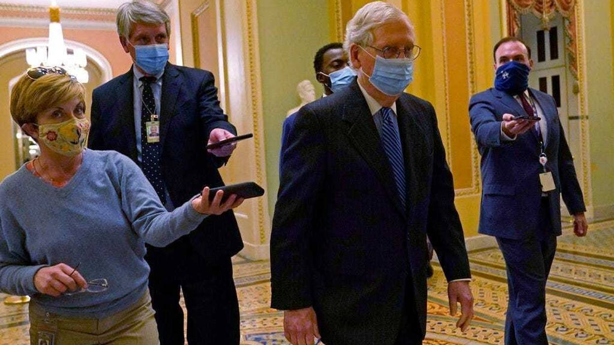 Senate Majority Leader Mitch McConnell of Ky., walks past reporters on Capitol Hill in Washington, Tuesday, Dec. 15, 2020.