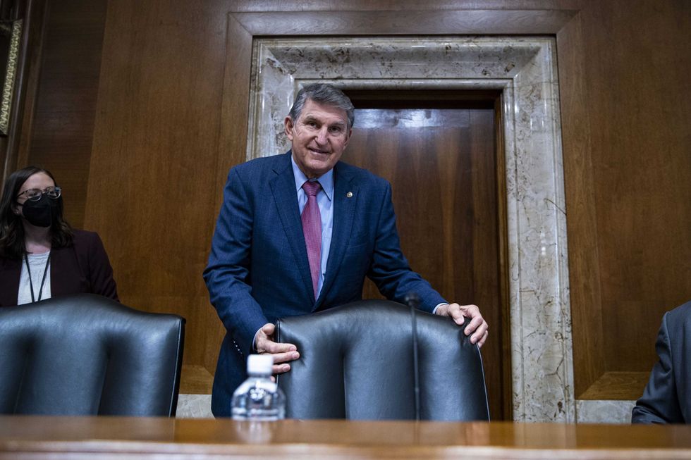 Senator Joe Manchin, a Democrat from West Virginia and chairman of the Senate Energy and Natural Resources Committee, arrives during a hearing in Washington, D.C., U.S., on Tuesday, Feb. 1, 2022. Senators negotiating a sanctions package intended to deter a Russian invasion of Ukraine said they