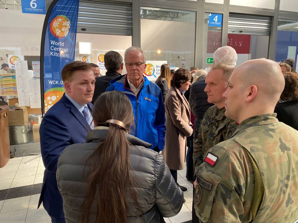 Senator Moran speaks with U.S. Consul General Patrick Slowinski and Polish military leaders during a tour of the refugee center on the Poland-Ukrainian border.