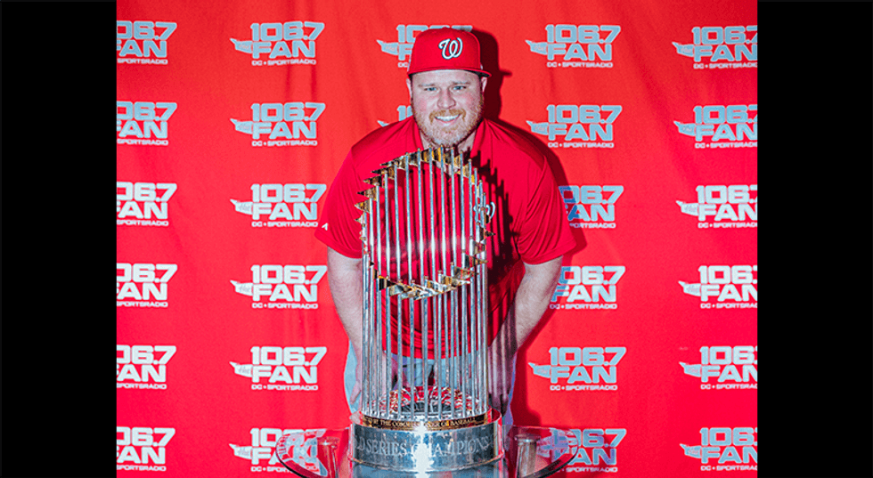 Senior 106.7 The Fan writer Chris Lingebach poses with the World Series Trophy