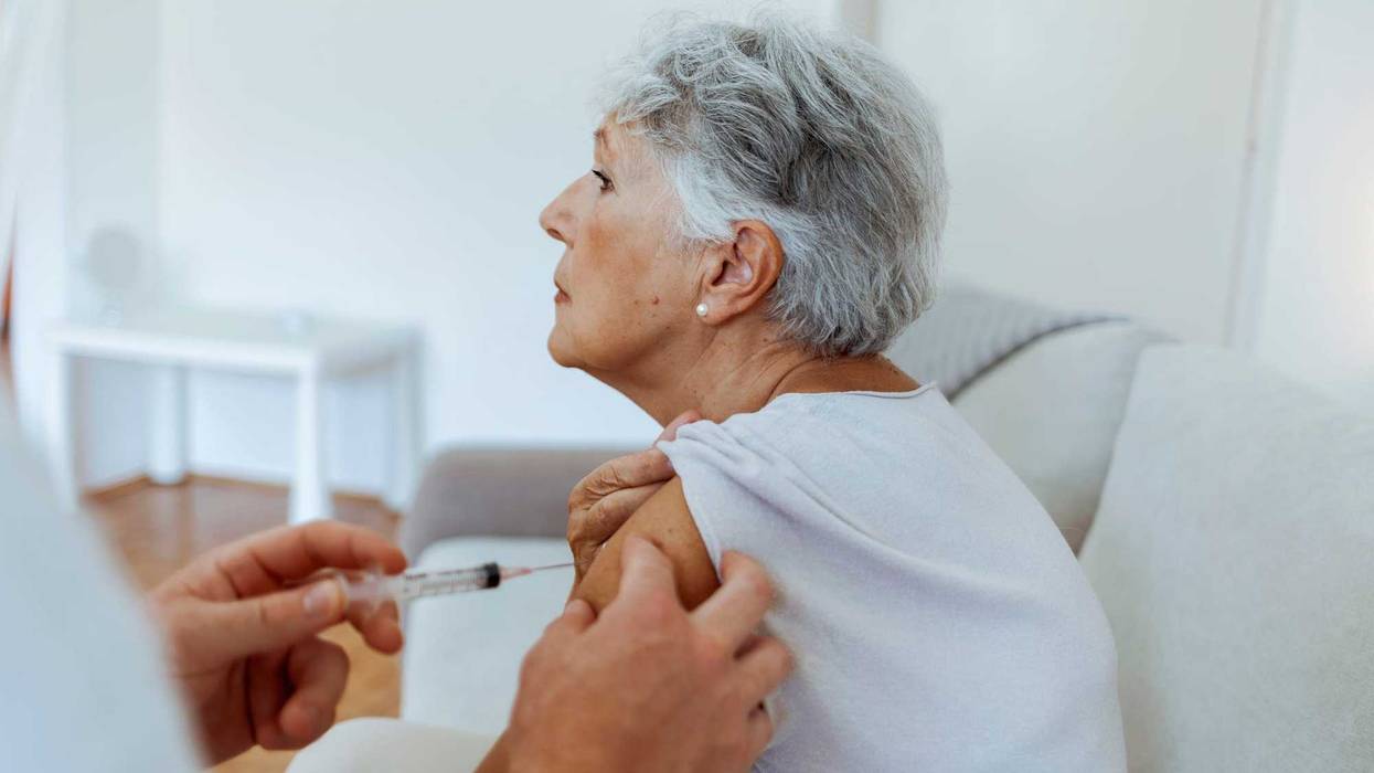 Senior woman getting vaccine stock photo.