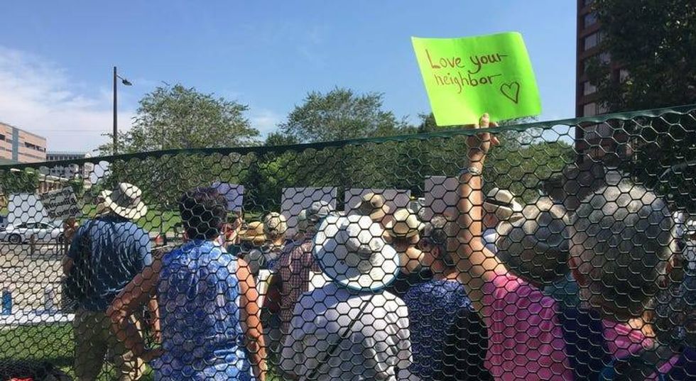Seniors protest US treatment of migrant kids by 'caging' themselves in excessive heat