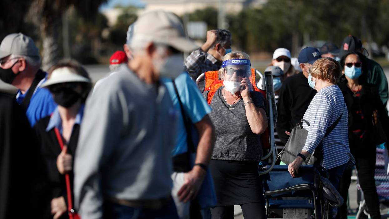 Seniors wait in line to receive a COVID-19 vaccine.
