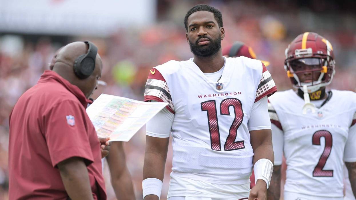 Sep 10, 2023; Landover, Maryland, USA; Washington Commanders quarterback Jacoby Brissett (12) stands with assistant head coach/offensive coordinator Eric Bieniemy during the first half Arizona Cardinals at FedExField.