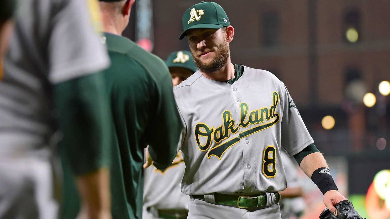 Sep 11, 2018; Baltimore, MD, USA; Oakland Athletics second baseman Jed Lowrie (8) high fives teammates after beating the Baltimore Orioles 3-2 at Oriole Park at Camden Yards. Mandatory Credit: Evan Habeeb-USA TODAY Sports