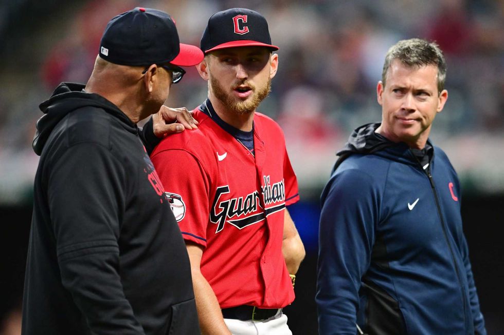 Sep 16, 2023; Cleveland, Ohio, USA; Cleveland Guardians starting pitcher Tanner Bibee (61) walks off the field with manager Terry Francona, left, and head athletic trainer James Quinlan, right, during the sixth inning against the Texas Rangers at Progressive Field. Bibee left the game with an injury.
