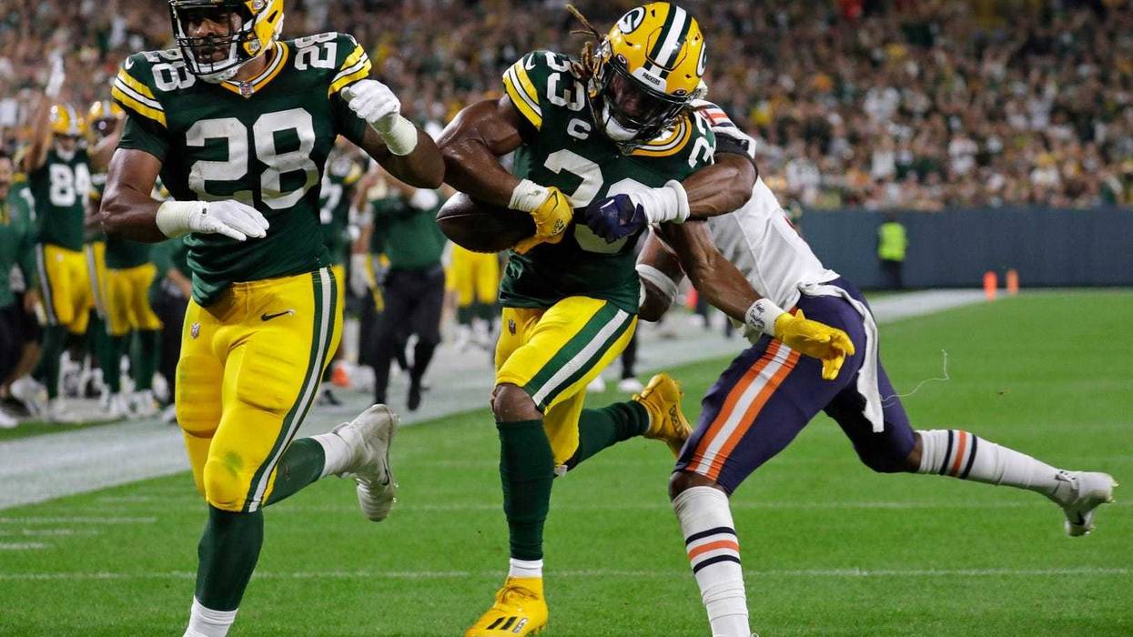 Sep 18, 2022; Green Bay, Wisconsin, USA; Green Bay Packers running back AJ Dillon (28) blocks for running back Aaron Jones (33) as he scores a touchdown against Chicago Bears safety Jaquan Brisker (9) in the second quarter during their football game at Lambeau Field. Mandatory Credit: Dan Powers/USA TODAY NETWORK-Wisconsin
