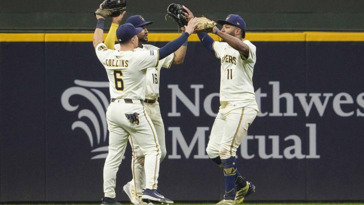 Sep 18, 2025; Milwaukee, Wisconsin, USA; Milwaukee Brewers outfielder Isaac Collins (6) Milwaukee Brewers outfielder Blake Perkins (16) and Milwaukee Brewers outfielder Jackson Chourio (11) celebrate a 5-2 win over the Los Angeles Angels at American Family Field. Mandatory Credit: Michael McLoone-Imagn Images