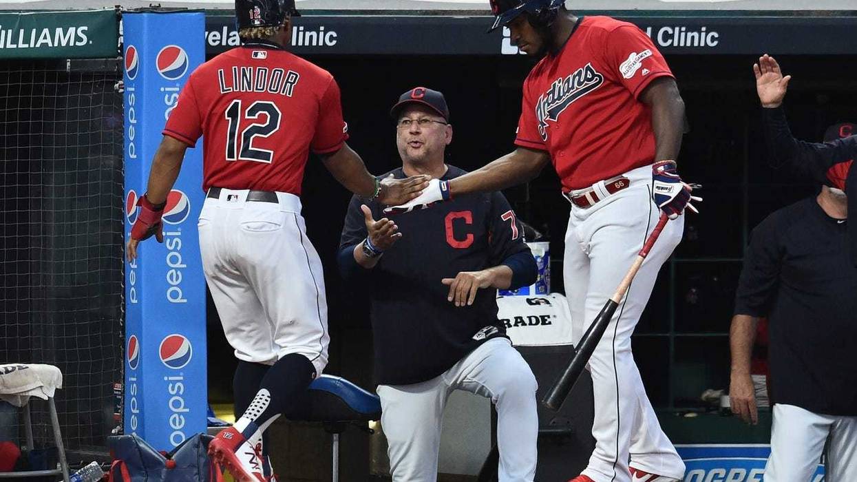 Sep 20, 2019; Cleveland, OH, USA; Cleveland Indians shortstop Francisco Lindor (12) celebrates with right fielder Yasiel Puig (66) and manager Terry Francona (77) during the first inning against the Philadelphia Phillies at Progressive Field. Mandatory Cr