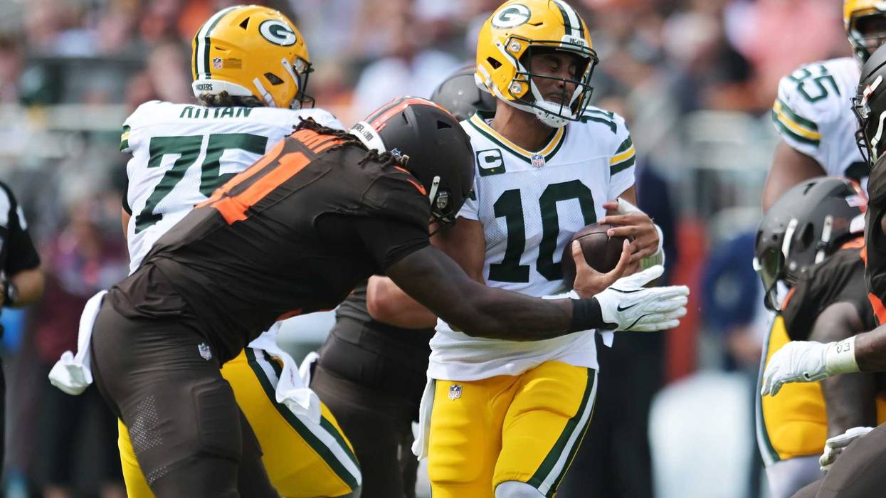Sep 21, 2025; Cleveland, Ohio, USA; Cleveland Browns defensive end Alex Wright (91) sacks Green Bay Packers quarterback Jordan Love (10) during the second quarter at Huntington Bank Field. Mandatory Credit: Ken Blaze-Imagn Images
