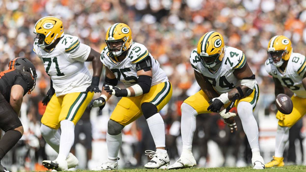 Sep 21, 2025; Cleveland, Ohio, USA; Green Bay Packers guard Elgton Jenkins (74) snaps the ball as guard Sean Rhyan (75) and offensive tackle Anthony Belton (71) move for blocks against the Cleveland Browns during the third quarter at Huntington Bank Field. Mandatory Credit: Scott Galvin-Imagn Images