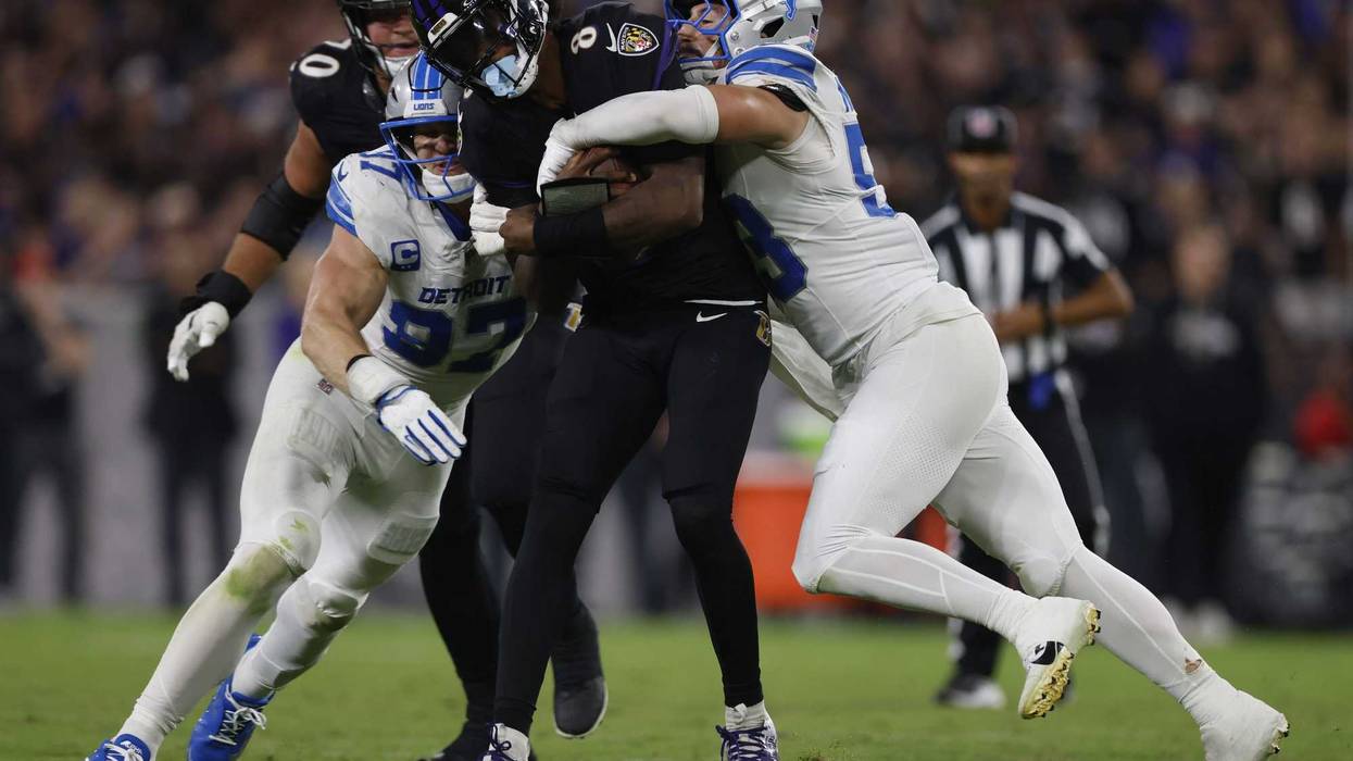 Sep 22, 2025; Baltimore, Maryland, USA; Detroit Lions linebacker Trevor Nowaske (53)and defensive end Aidan Hutchinson (97) tackles Baltimore Ravens quarterback Lamar Jackson (8) during the first half at M&T Bank Stadium.