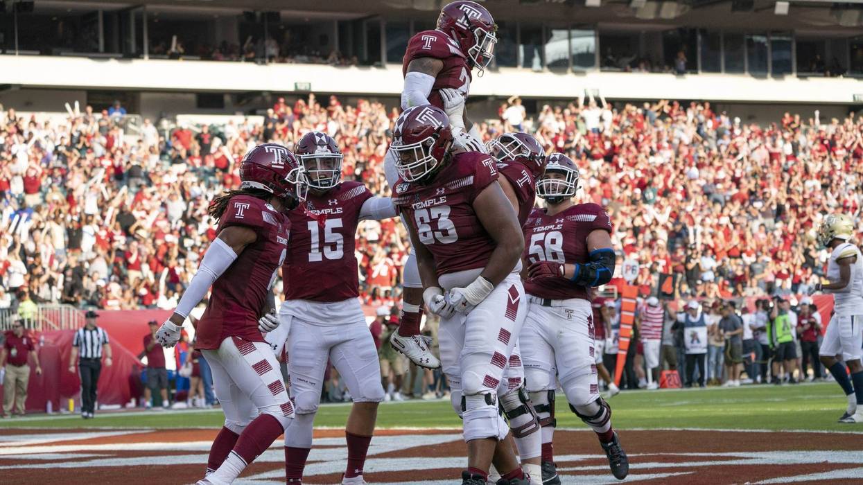 Sep 28, 2019; Philadelphia, PA, USA; Temple Owls offensive lineman Vincent Picozzi (76) lifts up Temple Owls running back Re'Mahn Davis (20) to celebrate his touchdown.