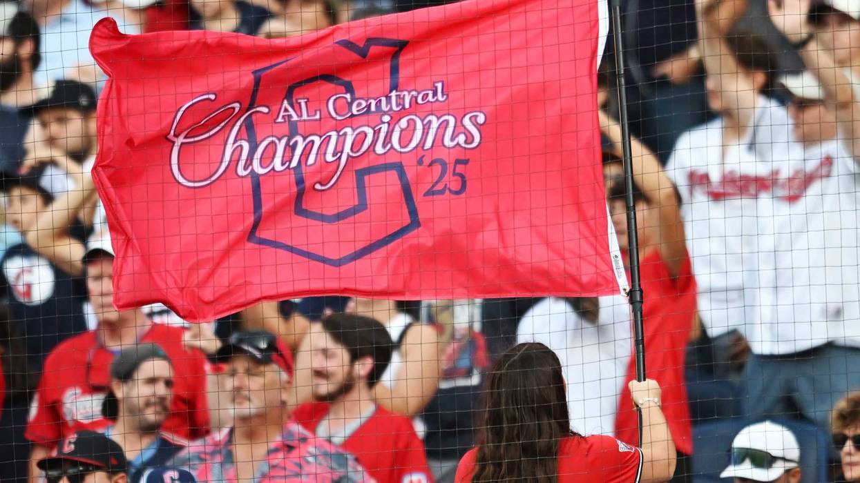 Sep 28, 2025; Cleveland, Ohio, USA; A member of the Cleveland Strikers waves an American League Central Division champions flag during the game between the Cleveland Guardians and the Texas Rangers at Progressive Field. Mandatory Credit: Ken Blaze-Imagn Images