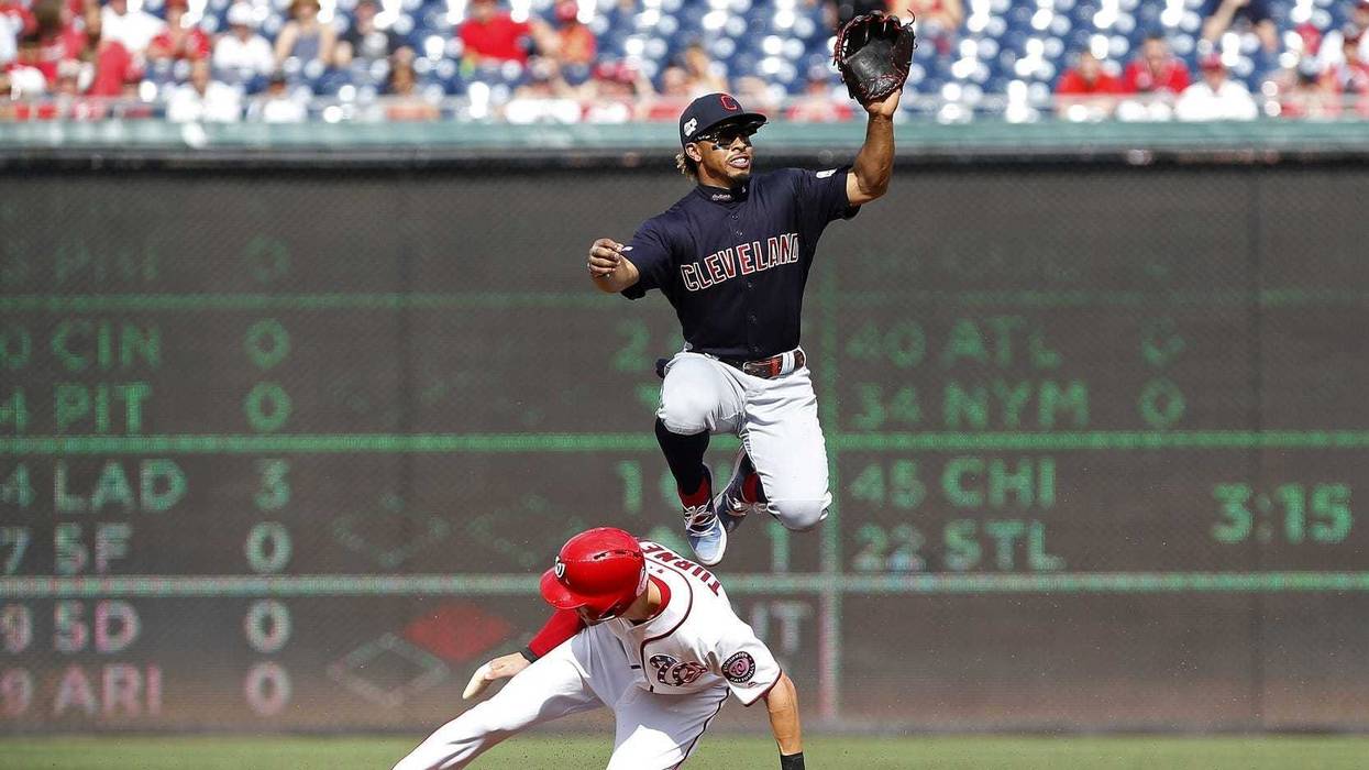 Sep 29, 2019; Washington, DC, USA; Washington Nationals shortstop Trea Turner (7) steals second base as Cleveland Indians shortstop Francisco Lindor (12) leaps to catch the throw from home plate in the first inning at Nationals Park. Mandatory Credit: Geo