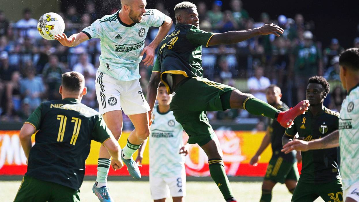 Sep 4, 2022; Portland, Oregon, USA; Atlanta United defender Andrew Gutman (15) and Portland Timbers forward Dairon Asprilla (27) battle for a header during the second half at Providence Park. The Timbers won 2-1.
